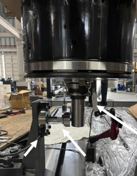 Real product testing image showing the physical validation setup at the spindle area with measurement fixtures and sensors
