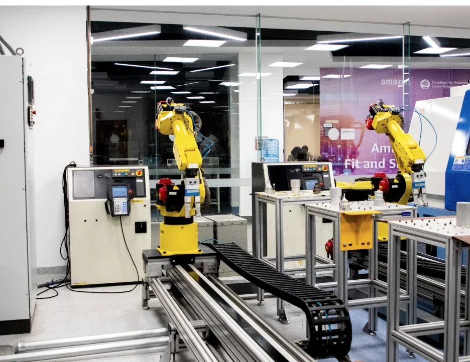 Industrial robotic automation cell with two robot arms, machine frames and operator stations