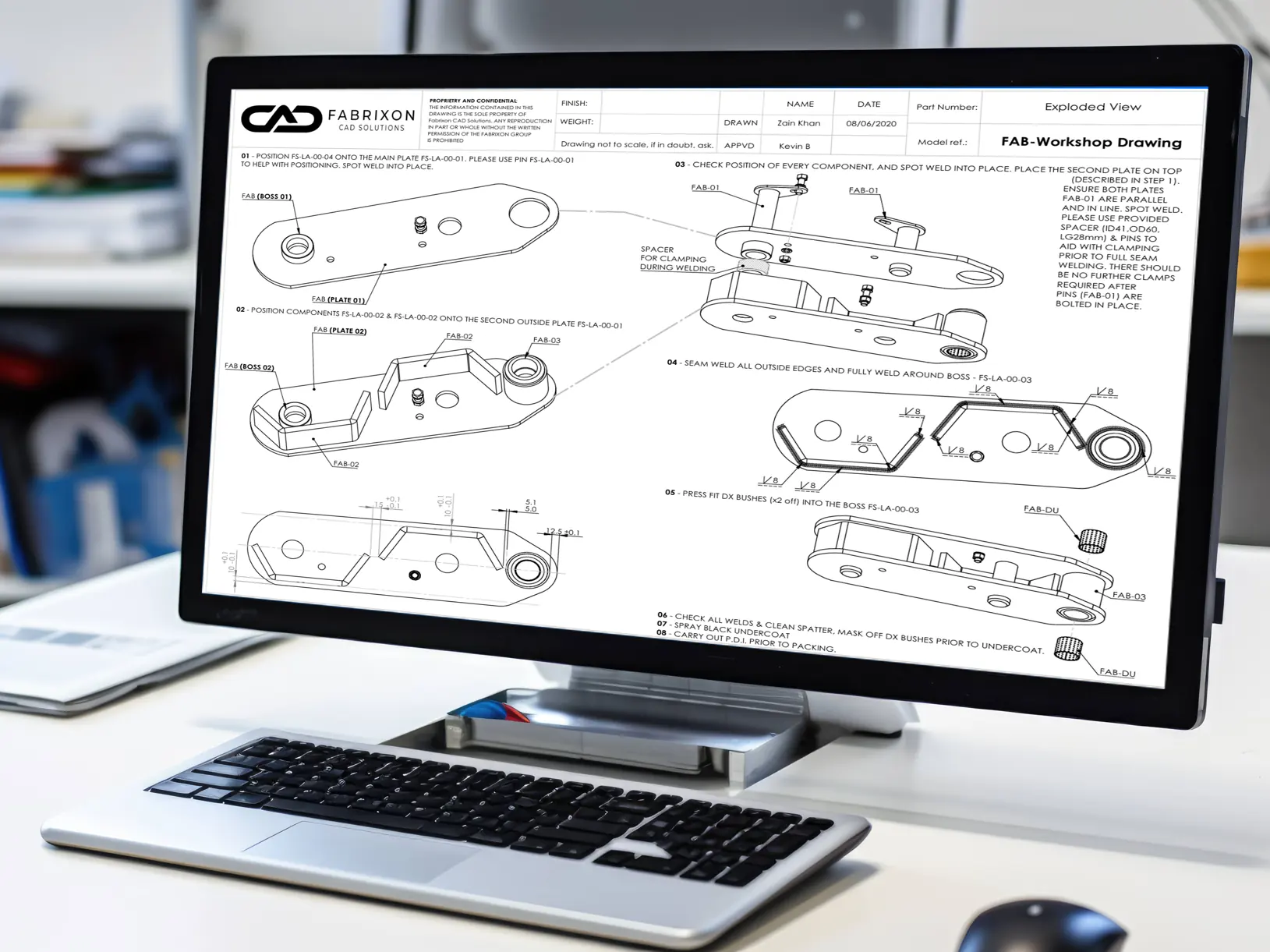 Exploded workshop drawing displayed on a desktop monitor in an engineering office